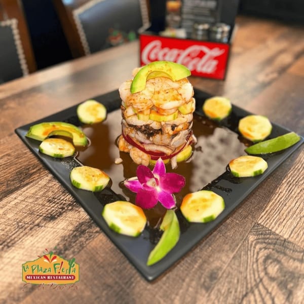 La Plaza Fiesta's shrimp tower with avocado, cucumber, and a purple orchid garnish.